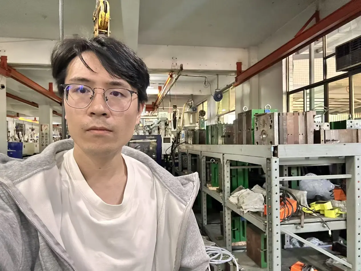 Carson GE in an injection molding workshop with molds stored on racks
