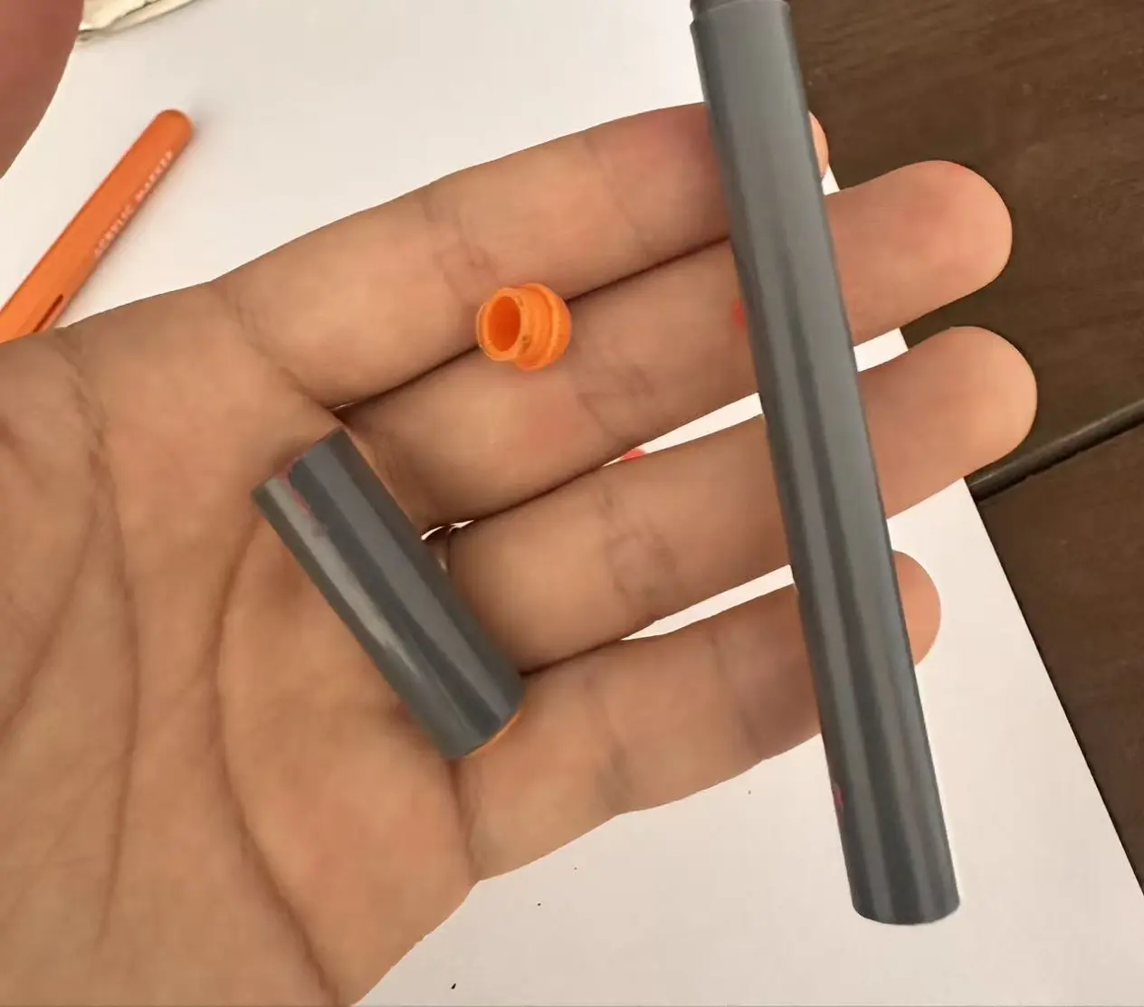 Marker parts taken apart: barrel, cap and end plug