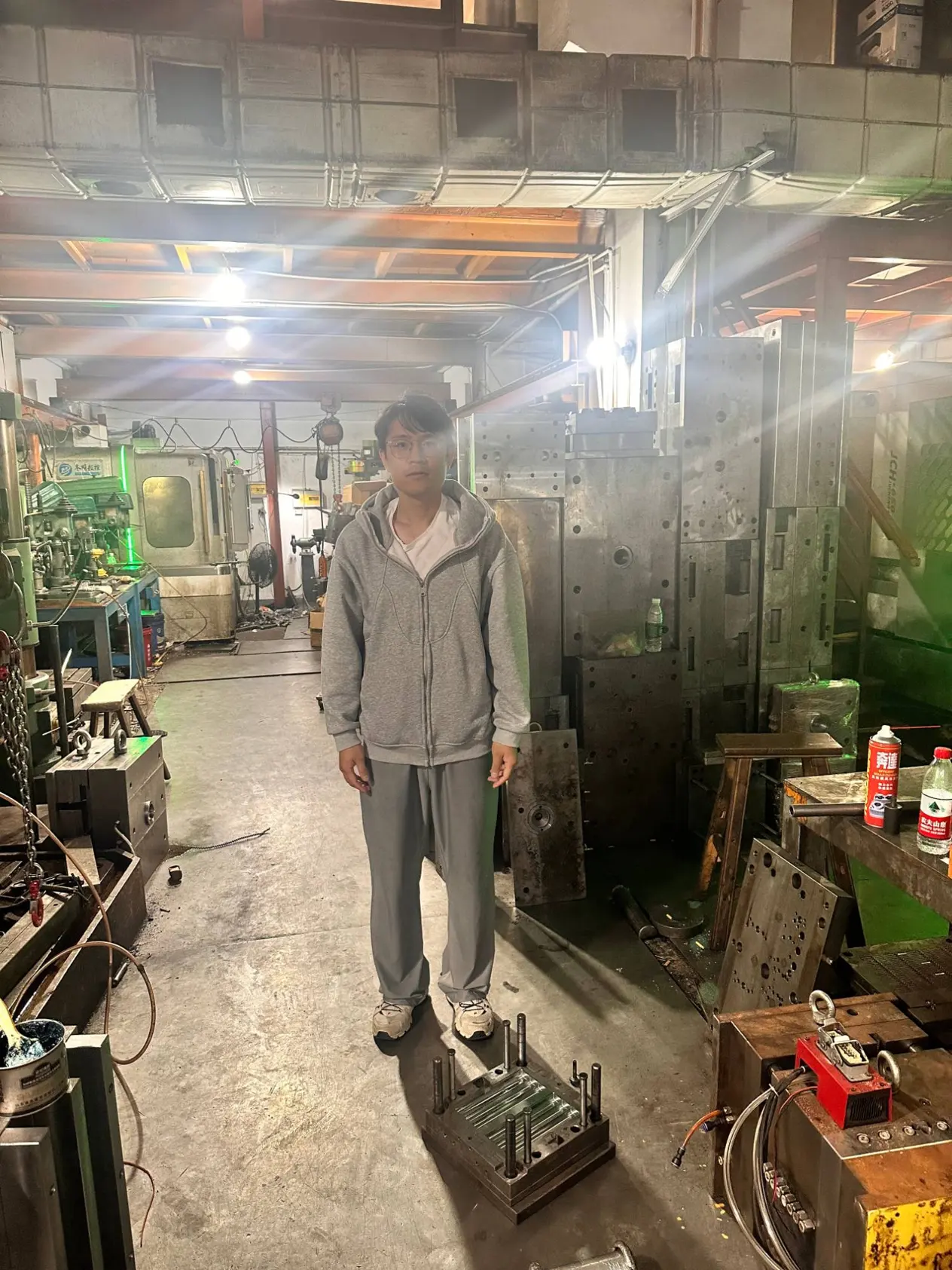 Carson GE in a mold workshop with steel mold plates and machine tools