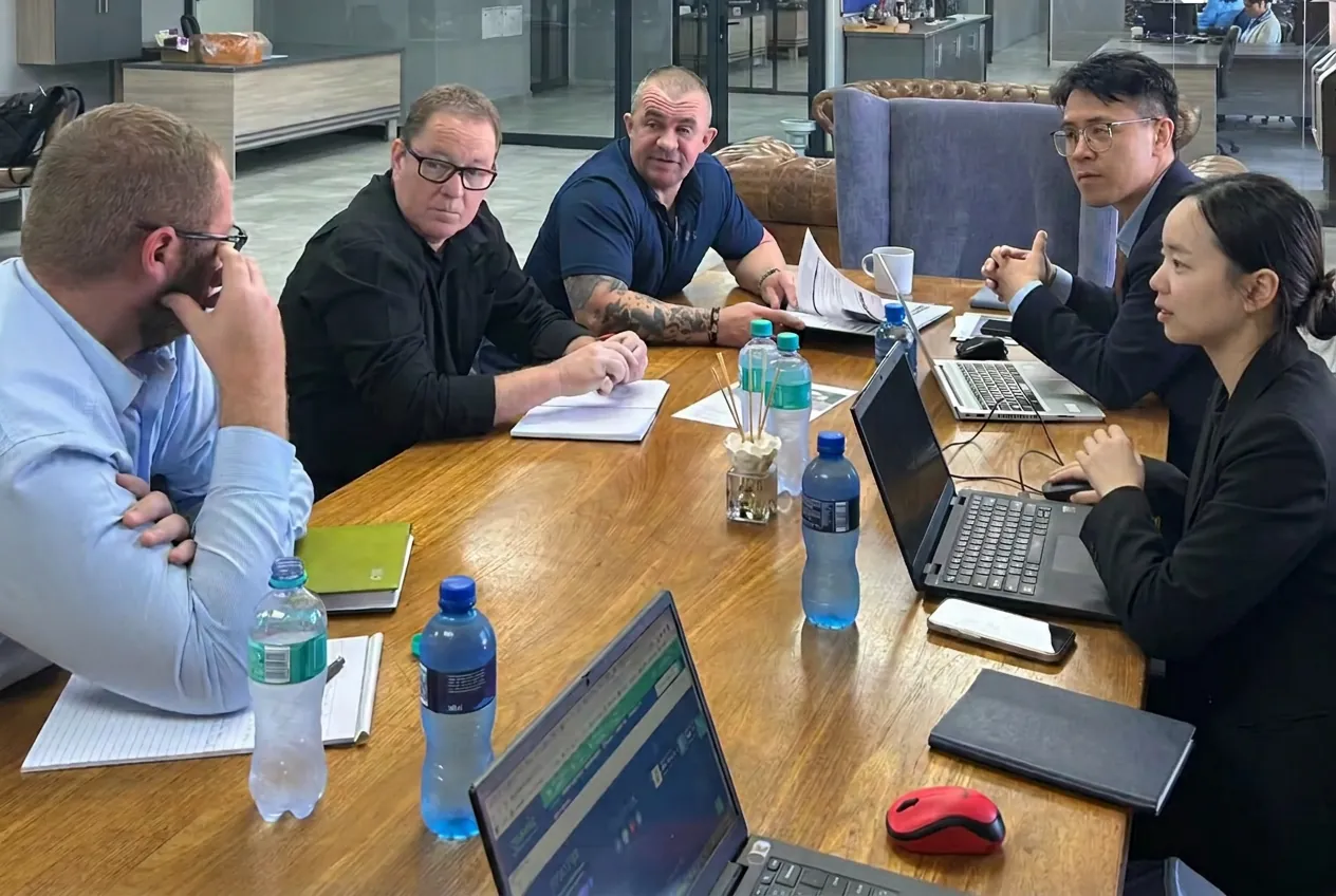 Buyers and sourcing team reviewing commercial terms in a meeting